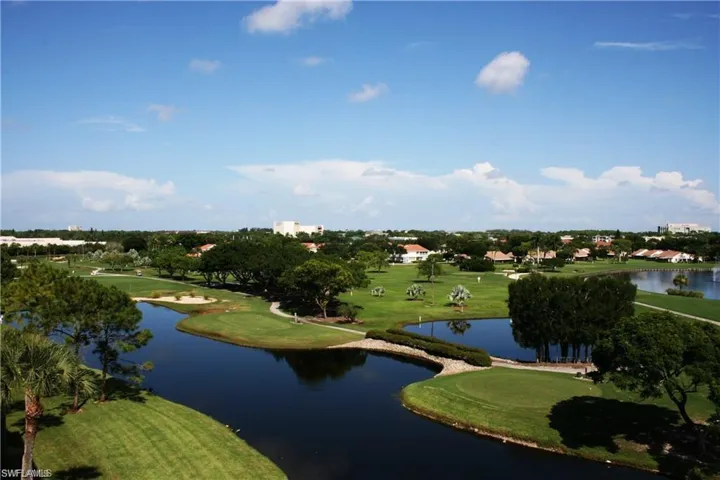 View of home's community featuring a water view, view of golf course, and a yard