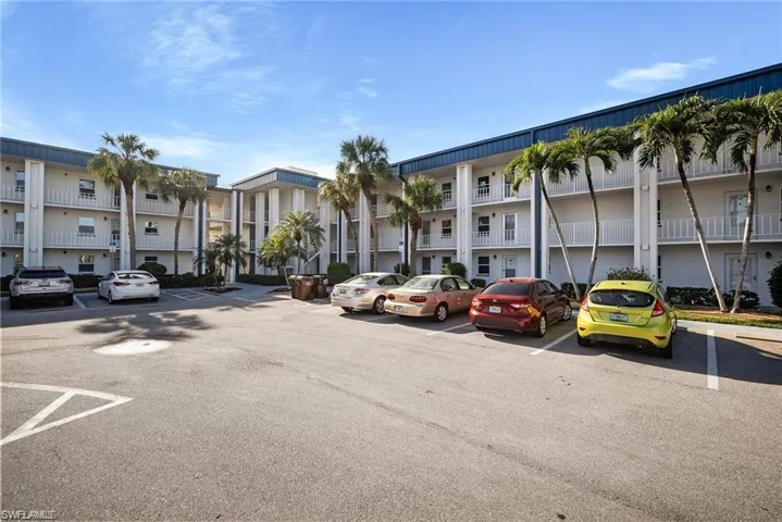 View of property featuring uncovered parking and a residential view