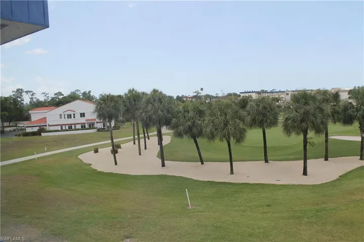 View of community featuring a lawn and golf course view