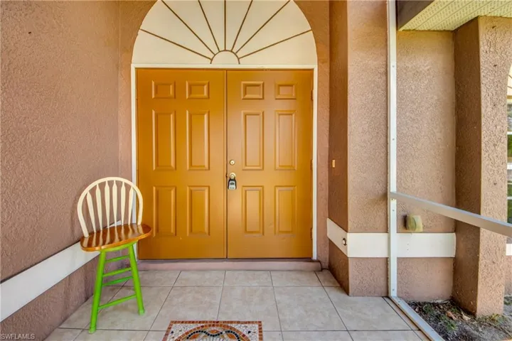 Entrance to property featuring stucco siding