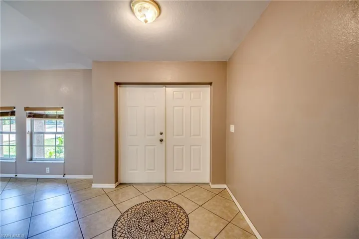 Foyer featuring baseboards and light tile patterned floors