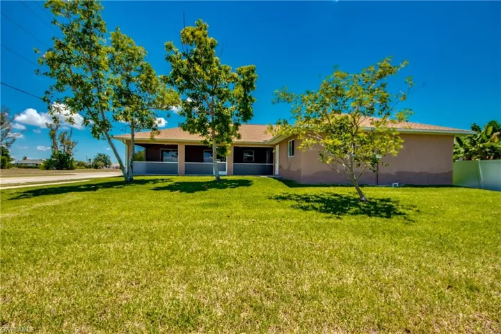 Back of property featuring stucco siding