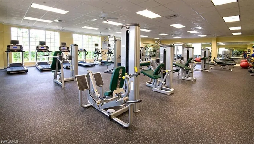 Gym featuring ceiling fan and a paneled ceiling