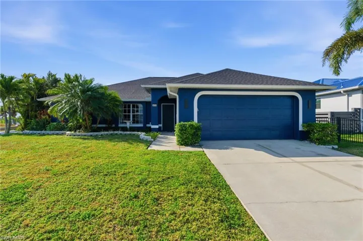 Ranch-style home featuring driveway, stucco siding, an attached garage, and roof with shingles