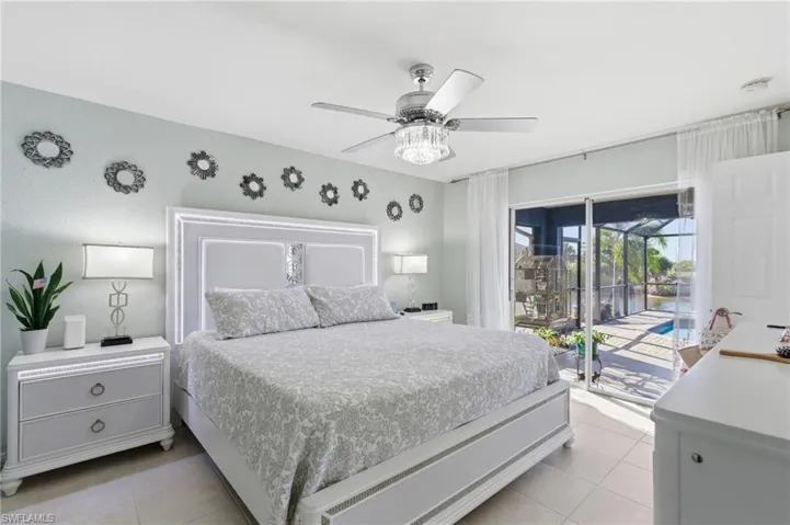 Bedroom with access to exterior, ceiling fan, and light tile patterned floors