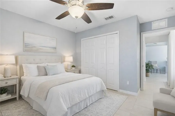 Bedroom with a ceiling fan, a closet, and light tile patterned floors