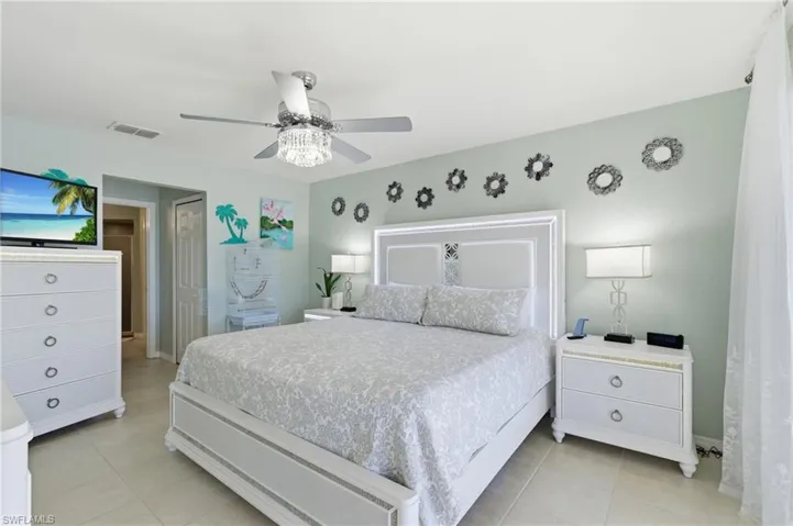 Bedroom featuring ceiling fan, a closet, and light tile patterned floors