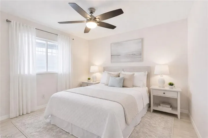 Bedroom with a ceiling fan and light wood-style flooring