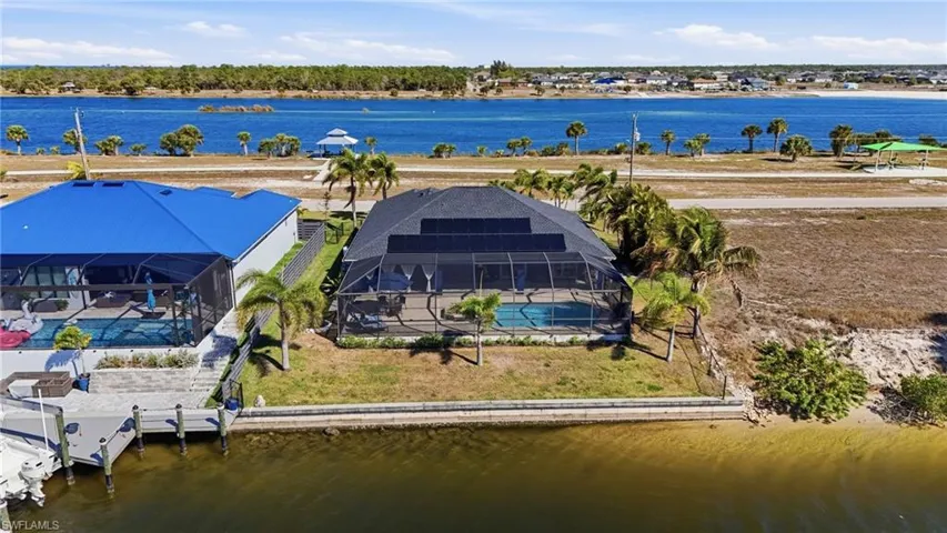 Aerial view of property and surrounding area featuring a large body of water