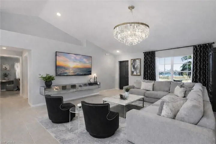 Living area with lofted ceiling and a chandelier