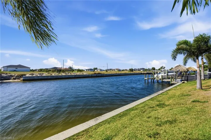 Dock featuring a water view and a lawn