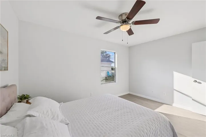 Bedroom with wood finished floors and ceiling fan