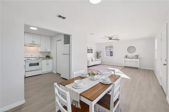 Dining room with a ceiling fan and light wood-style floors