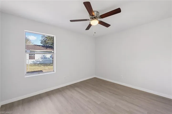 Unfurnished room with light wood finished floors and ceiling fan