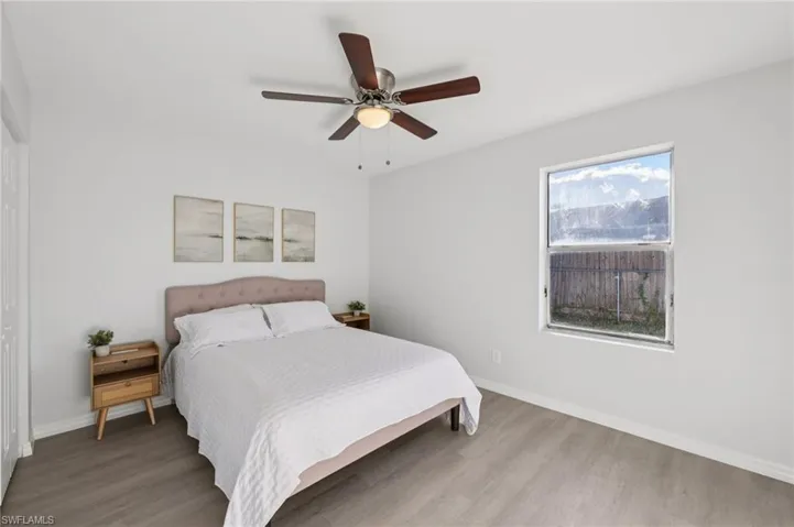 Bedroom featuring wood finished floors and a ceiling fan