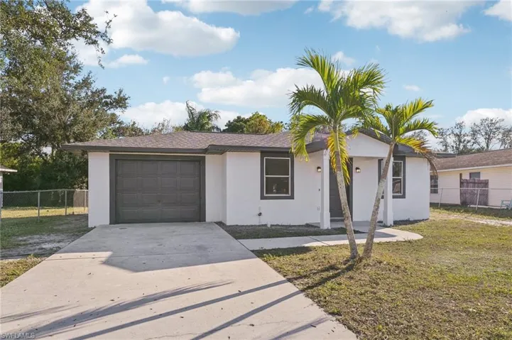 Ranch-style house with driveway, stucco siding, and an attached garage