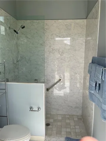 Bathroom with tiled shower and toilet