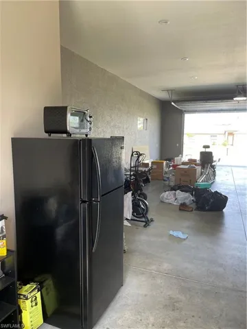 Garage featuring refrigerator