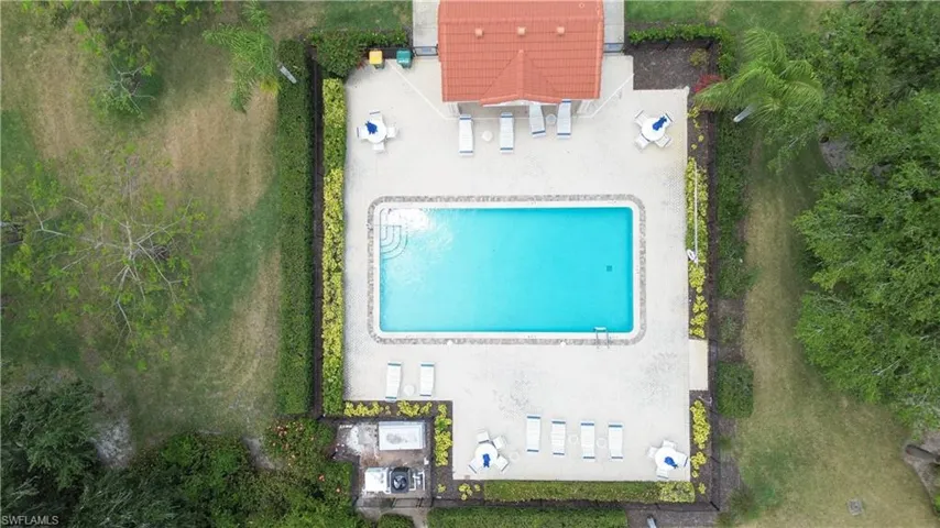 Aerial view of property and surrounding area with a pool area
