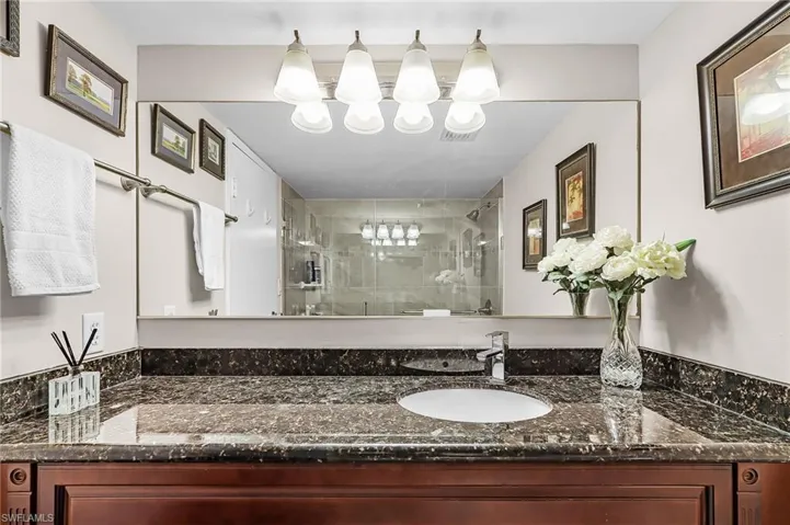 Full bath featuring a shower stall and vanity