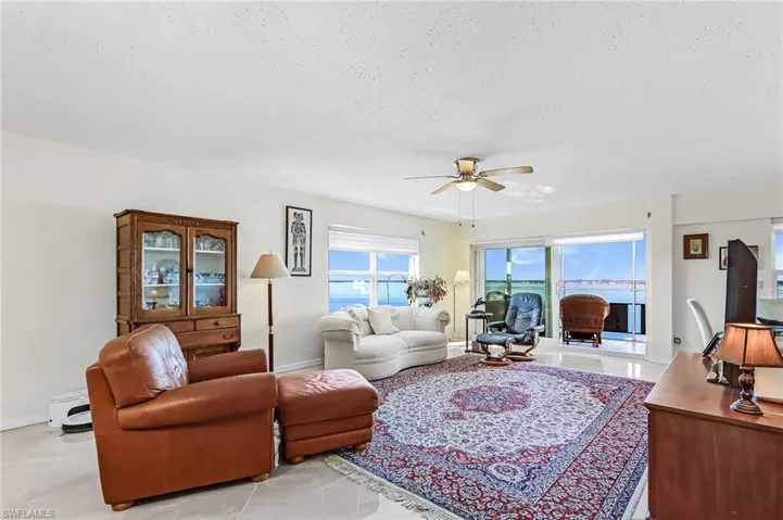 Living area featuring a ceiling fan, a textured ceiling, and a baseboard radiator