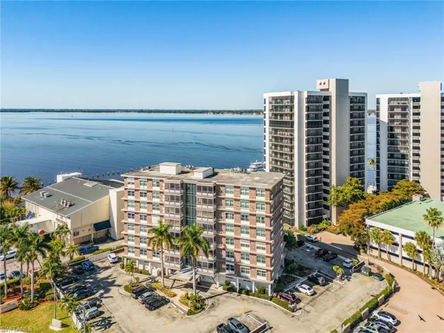 Aerial view of apartment complex and a large body of water