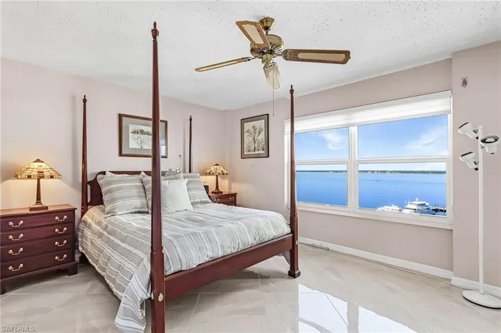 Bedroom featuring a water view and ceiling fan