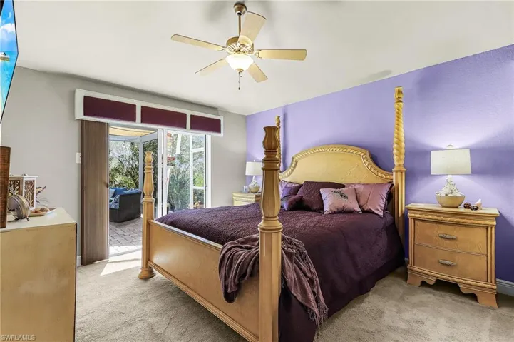 Bedroom featuring light carpet, access to outside, and ceiling fan