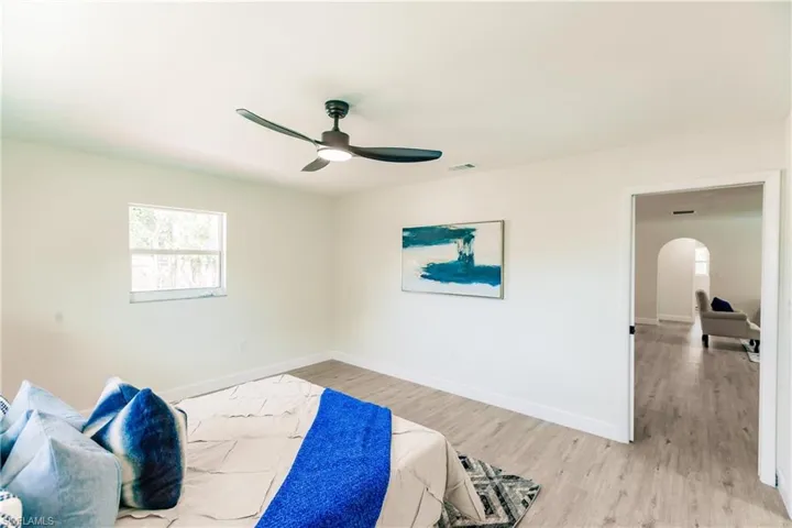 Bedroom with wood-type flooring and ceiling fan