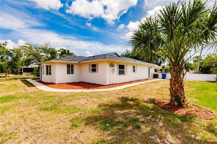 Back of property featuring a yard