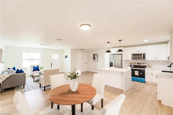 Dining area featuring sink and light hardwood / wood-style flooring