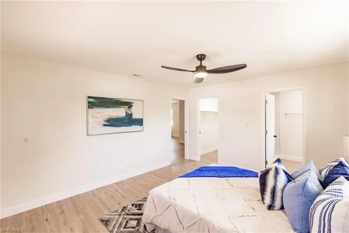Bedroom with ceiling fan and light hardwood / wood-style floors