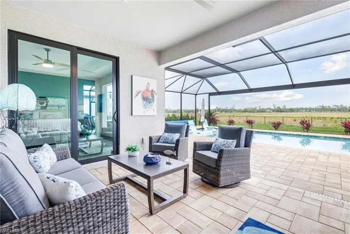 View of patio with a lanai, outdoor lounge area, and an outdoor pool