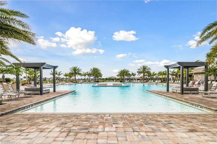 Pool with a jacuzzi and a patio