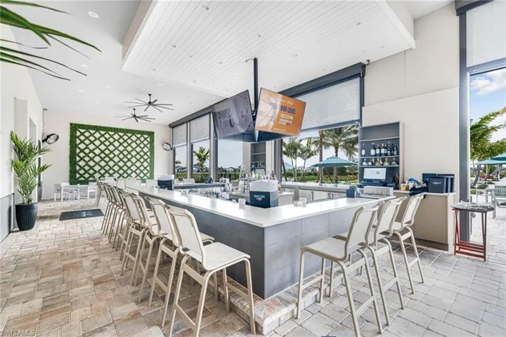 Kitchen featuring recessed lighting, a healthy amount of sunlight, ceiling fan, and stone tile floors