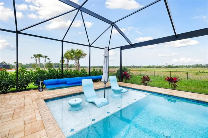 Outdoor pool with a patio area, a lanai, and fence