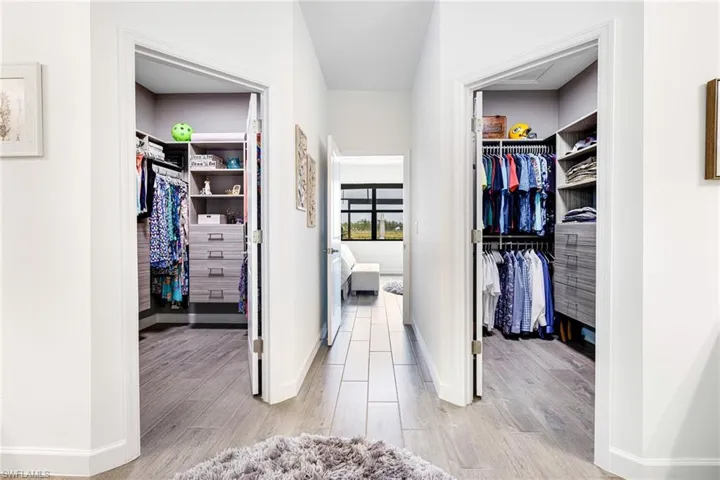 Walk in closet with light wood finished floors