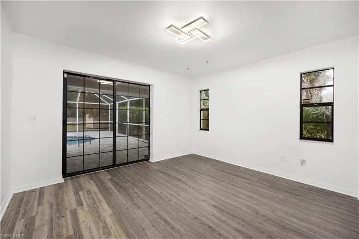Empty room featuring wood finished floors and baseboards