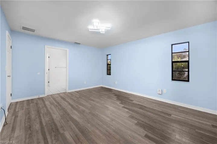 Empty room with wood finished floors and baseboards