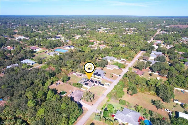 Aerial view of property's location featuring nearby suburban area