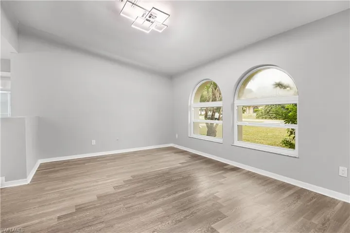 Unfurnished room with light wood-style floors and baseboards