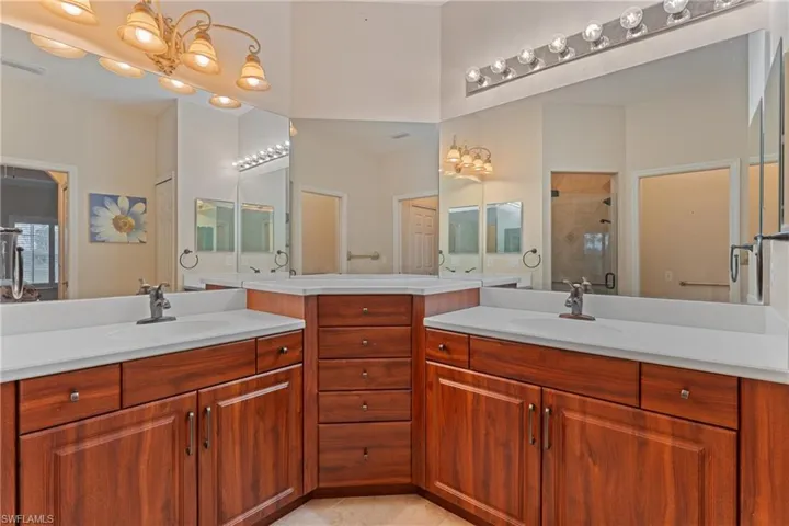 Bathroom featuring vanity, tile patterned floors, and a shower with door