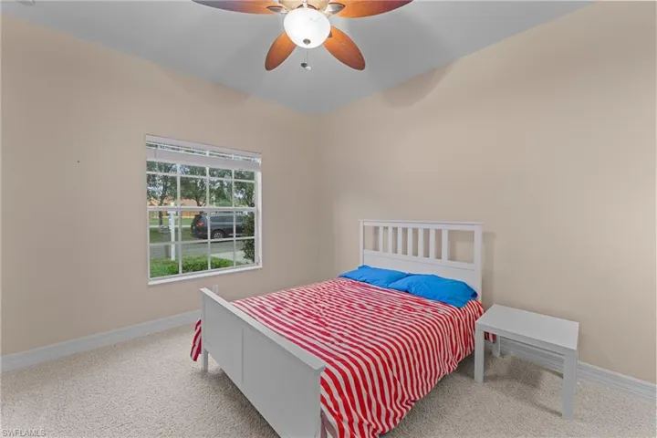Carpeted bedroom with ceiling fan