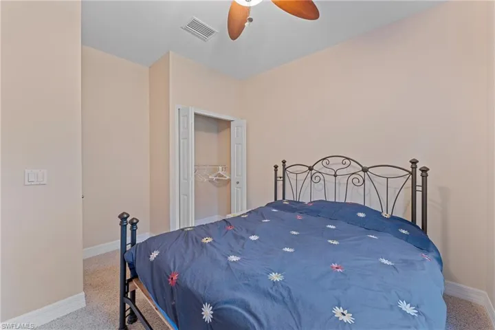 Bedroom with ceiling fan, carpet, and a closet