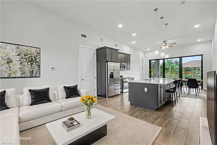 Living area with ceiling fan, wood finish floors, and recessed lighting