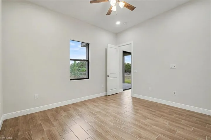 Spare room with wood finish floors, ceiling fan, and recessed lighting