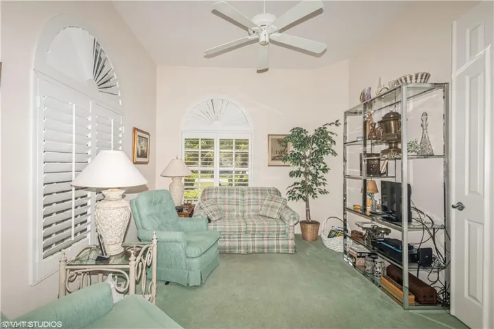 Living area with carpet flooring and ceiling fan