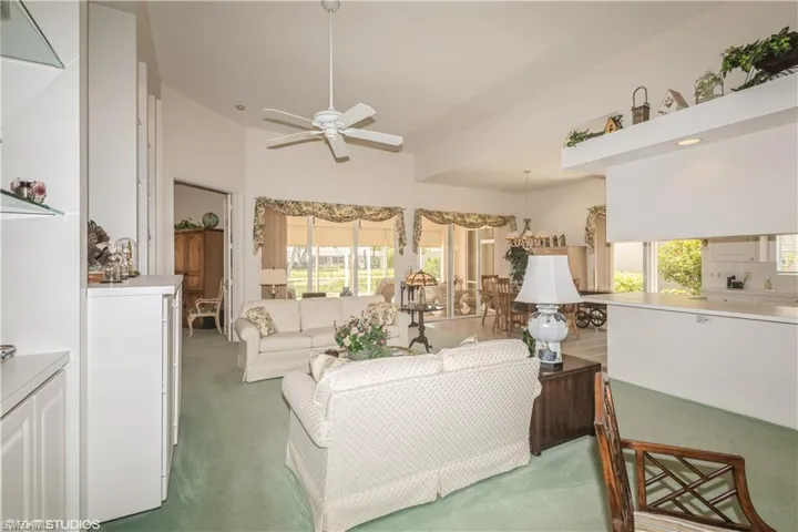 Living room featuring ceiling fan and carpet floors