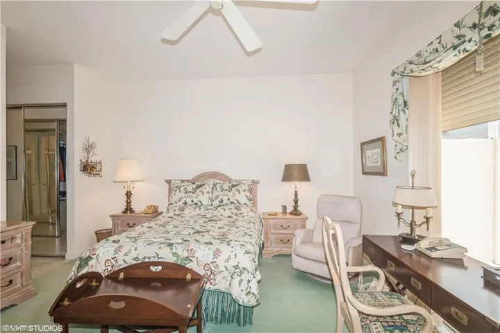 Carpeted bedroom with ceiling fan