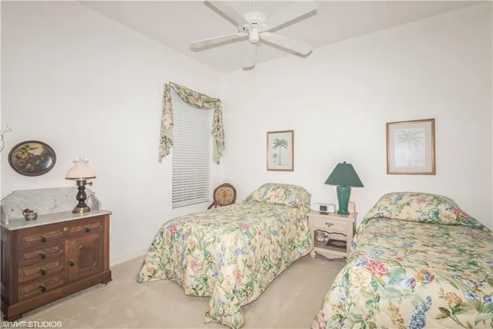 Carpeted bedroom with ceiling fan